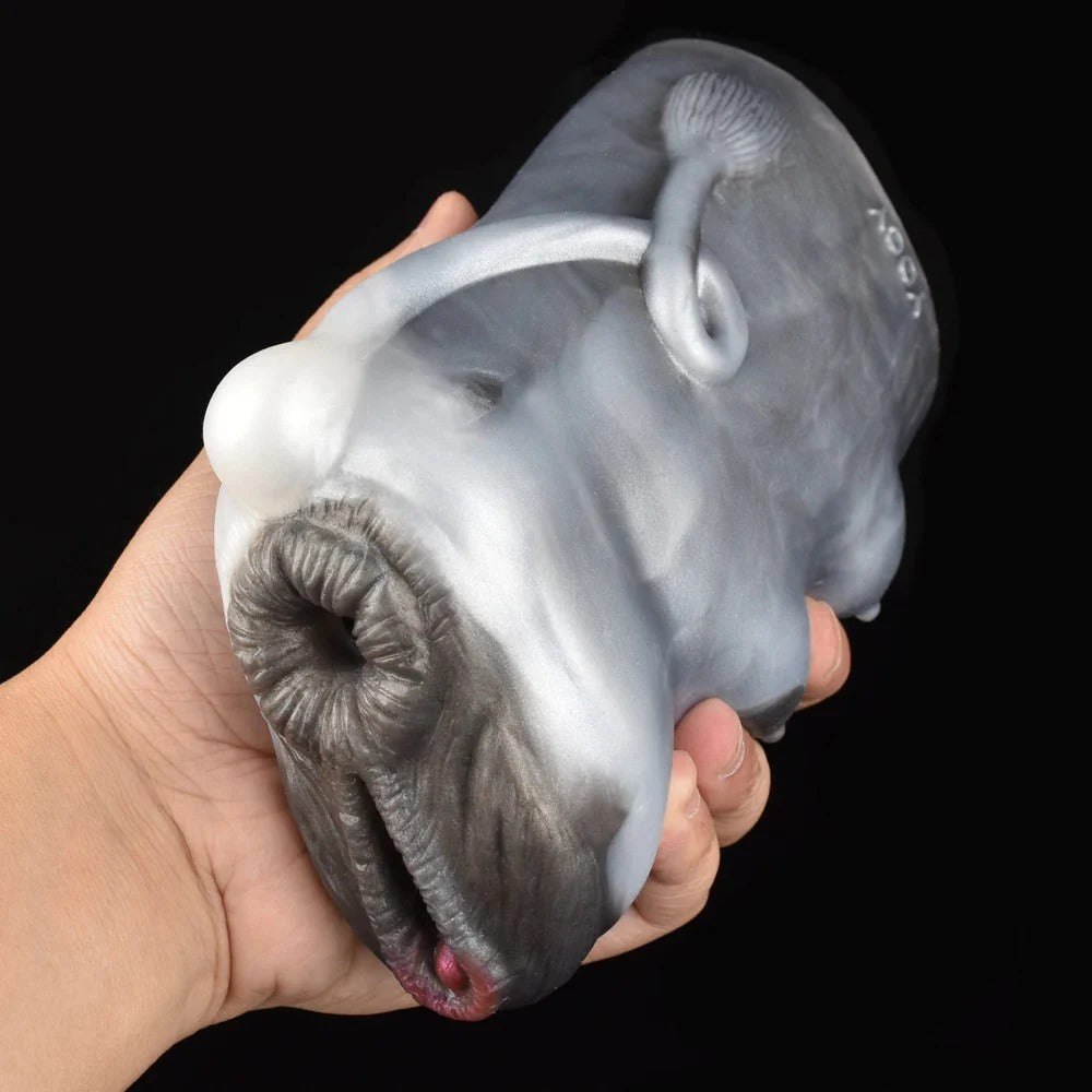 Realistic oral sex toy with detailed lips, tongue, and soft silicone texture held in hand