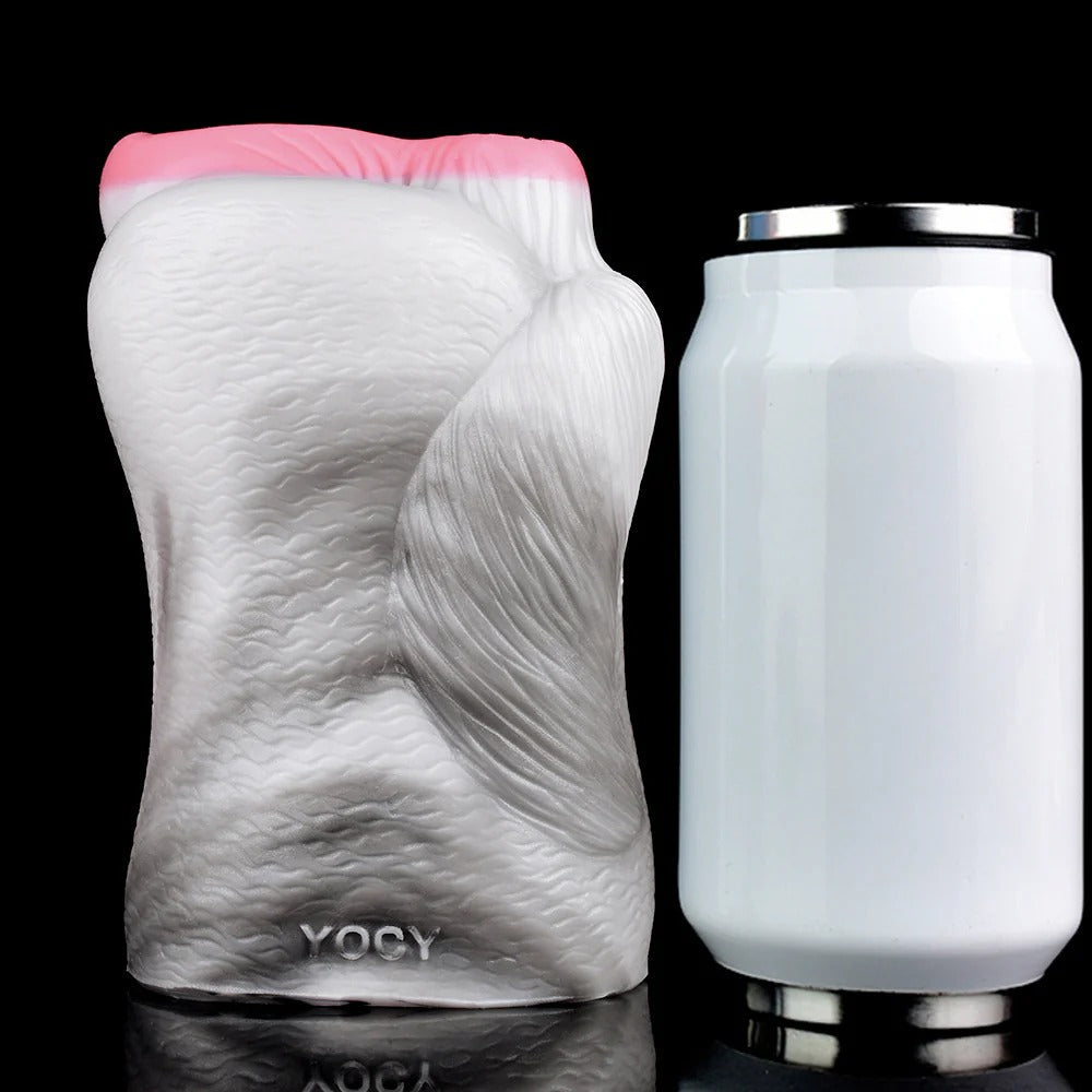 Realistic male masturbator with textured skin, pink opening, and YOCY branding, shown beside a can for scale