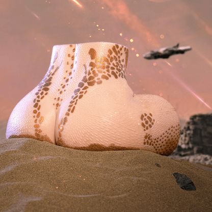 Realistic male masturbator with textured skin, gold speckles, and curved shape on sandy surface