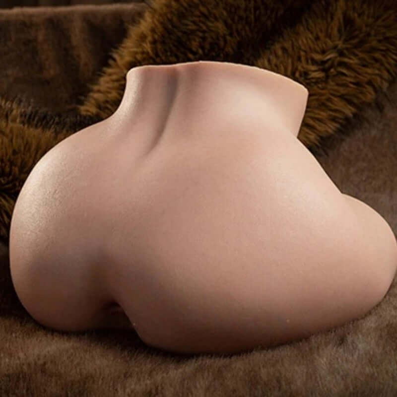 Realistic silicone male masturbator with lifelike curves and smooth skin texture on plush brown fur
