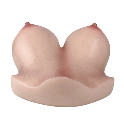 Realistic silicone breast-shaped male masturbator with natural skin texture and soft pink tone