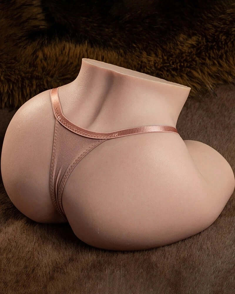 Realistic silicone torso with rose gold thong, smooth skin texture, resting on faux fur