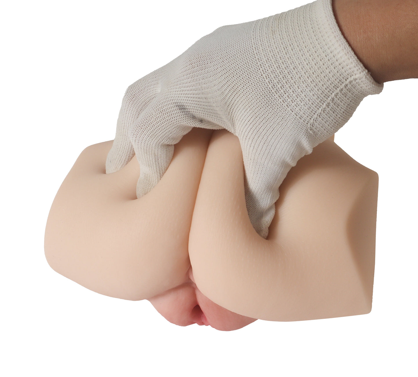 Hand in textured glove gripping realistic silicone male masturbator with detailed contours