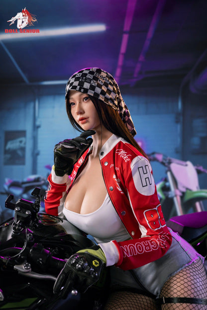 Realistic female doll in red racing jacket, checkered bandana, fishnet stockings, posed on motorcycle under neon lights