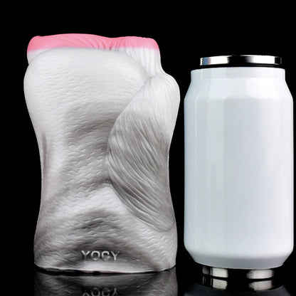 Realistic male masturbator with textured skin, pink opening, and YOCY branding, shown beside a can for scale