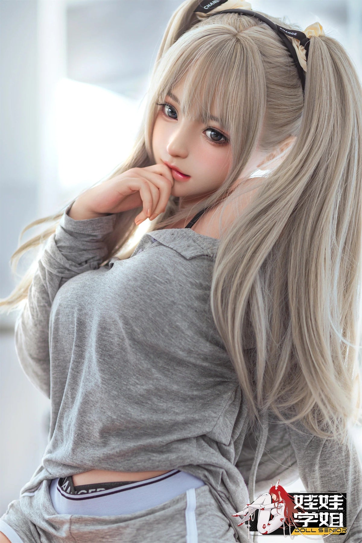 Realistic love doll with long blonde hair, grey top, and detailed facial features for intimate companionship.
