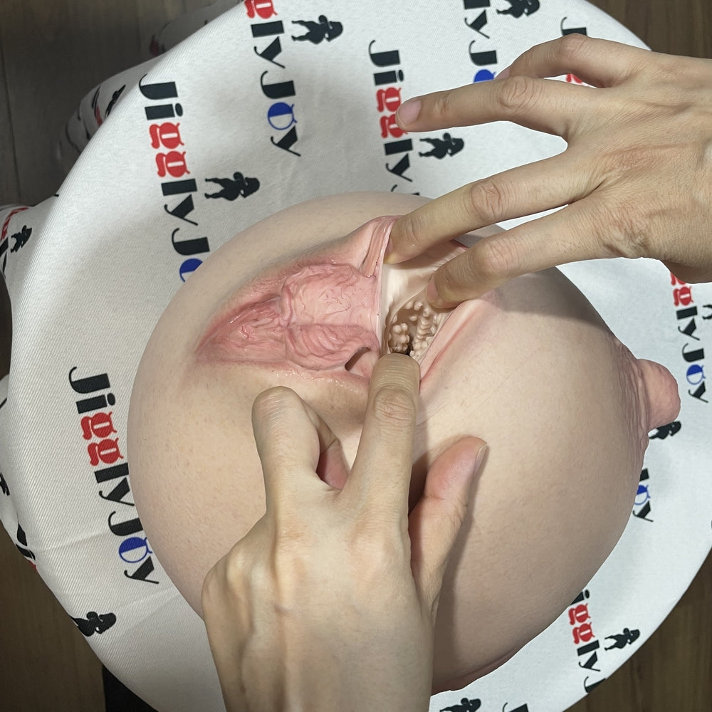 Realistic flesh-toned male masturbator with detailed vaginal texture and labia, shown with hands demonstrating internal ridges
