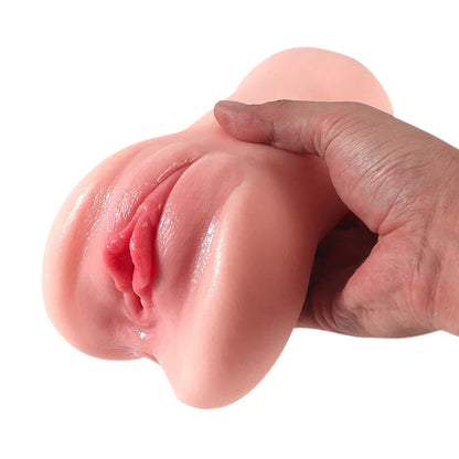 Realistic pink silicone male masturbator with detailed labia and natural texture held in hand