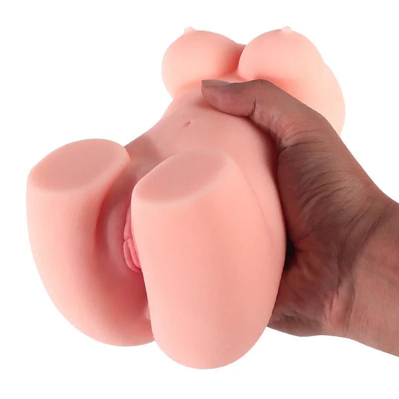 Soft pink silicone male masturbator with realistic curves and textured entrance, held in hand for scale
