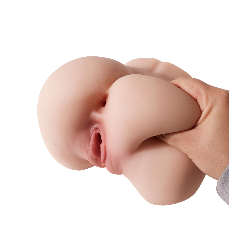 Realistic flesh-toned male masturbator with detailed labia and soft silicone texture, held in hand