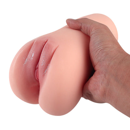 Hand holding realistic flesh-toned male masturbator with detailed labia and soft silicone texture